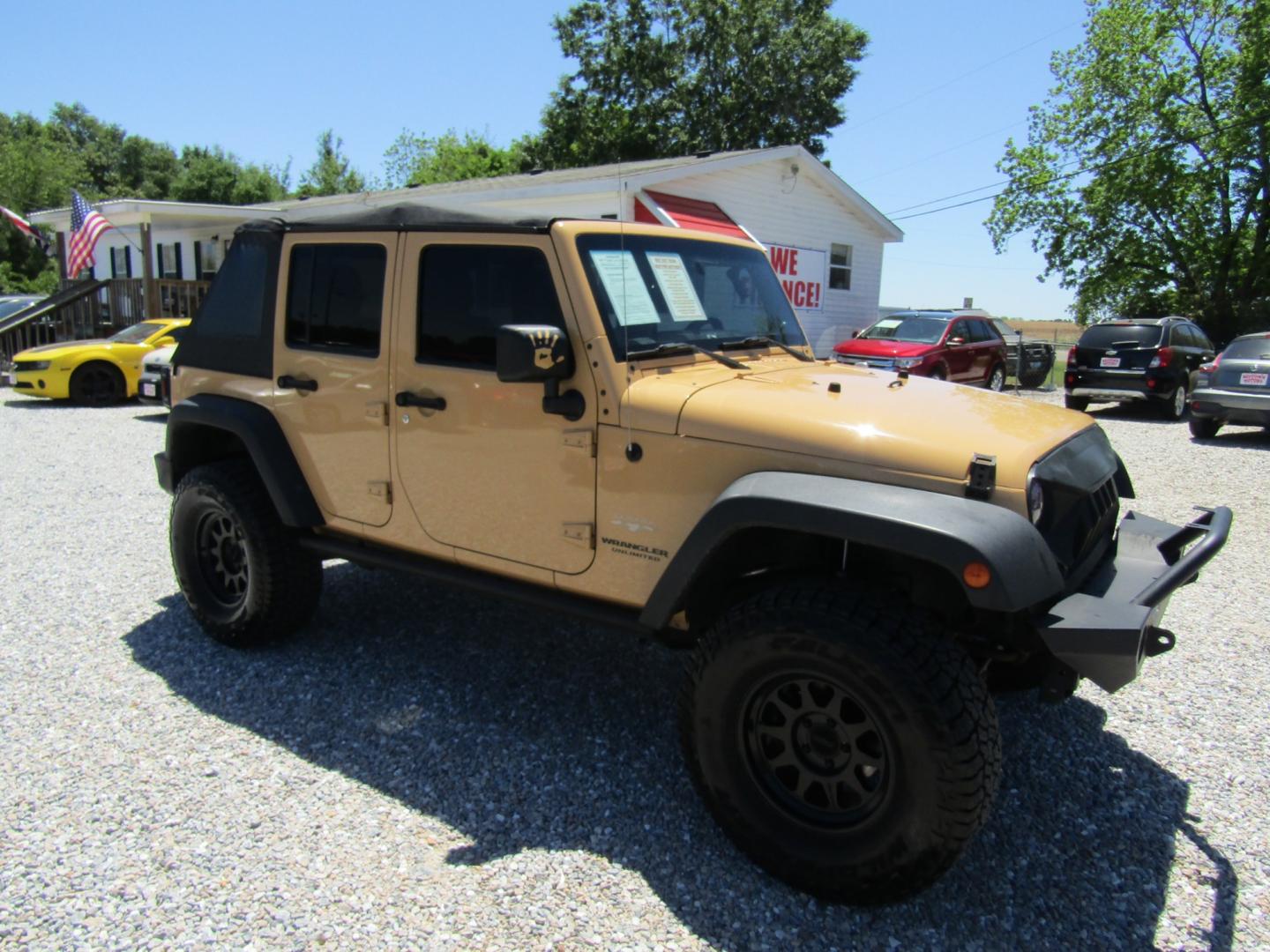 2013 Tan /Black Jeep Wrangler Unlimited Sahara 4WD (1C4HJWEG7DL) with an 3.6L V6 DOHC 24V FFV engine, Automatic transmission, located at 15016 S Hwy 231, Midland City, AL, 36350, (334) 983-3001, 31.306210, -85.495277 - Photo#0